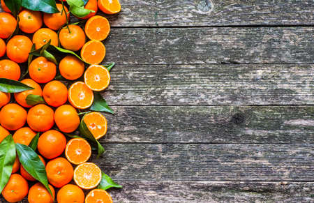 Fresh mandarin oranges fruit on wooden tableの写真素材