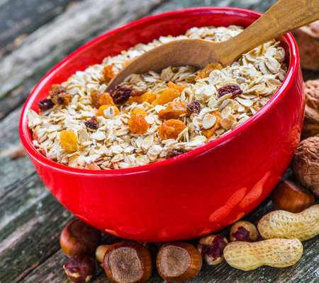 Oatmeal or oat flakes on dark wooden tableの写真素材