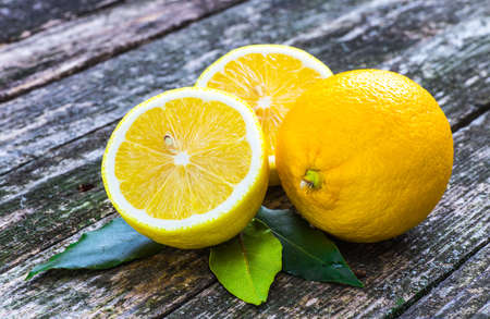 Pile of lemons on wooden tableの写真素材