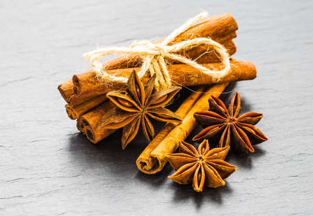 Mulled wine ingredients spices. Anise, cinnamon, cardamom on stone table.