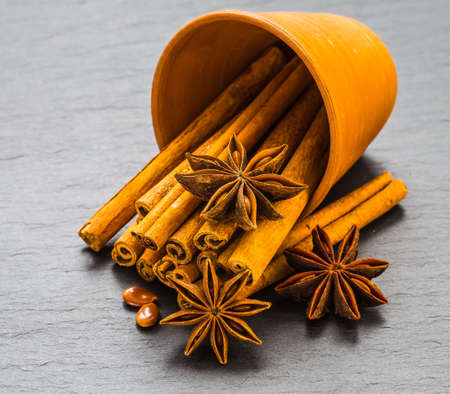 Mulled wine ingredients spices. Anise, cinnamon, cardamom on stone table.の写真素材