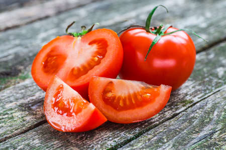 Close-up of fresh, ripe tomatoes on wood background