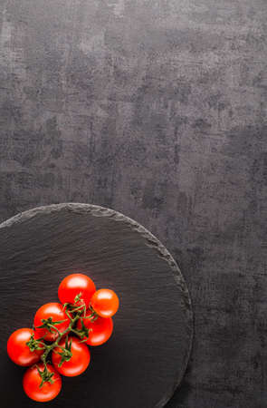 Vegetables. Peppers, tomatoes, garlic, onions on a black backgroundの写真素材