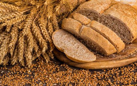 Assortment of baked bread on wooden table backgroundの写真素材