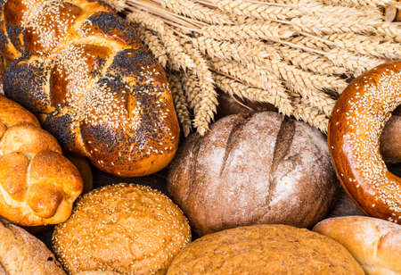 Many mixed breads and rolls shot from above.