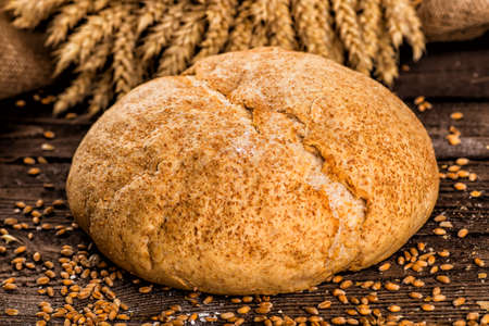 Assortment of baked bread on wooden table background