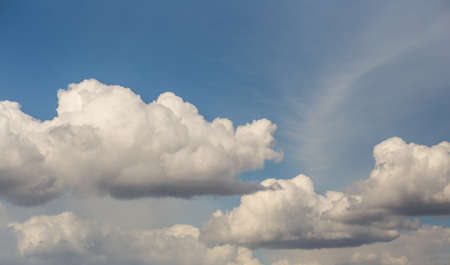 Blue sky with clouds and sun.