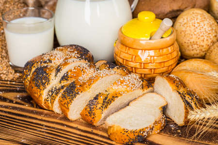 Assortment of baked bread on wooden table background