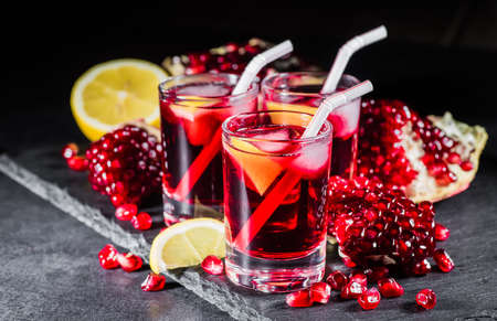 Fresh red juice cocktail with pomegranate seeds and iceの写真素材