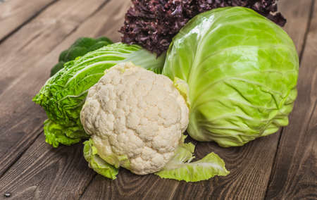 Fresh green garden cabbage on rustic wooden background. Vegetarian food. Assortment of fresh fruits and vegetablesの写真素材