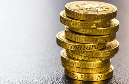 British coins stack on black, pound sterling