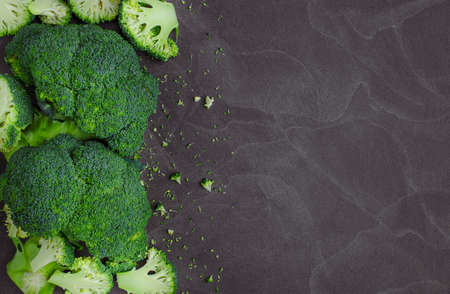 Fresh broccoli on dark wooden table background. top view