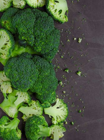 Fresh broccoli on dark wooden table background. top viewの写真素材