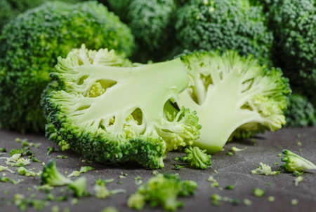 Pieces of broccoli, rustic style, old wooden backgroundの写真素材
