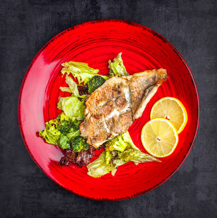 Baked seabass with Greek salad. Top viewの写真素材