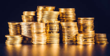 pound GBP coin and gold money on the deskの写真素材