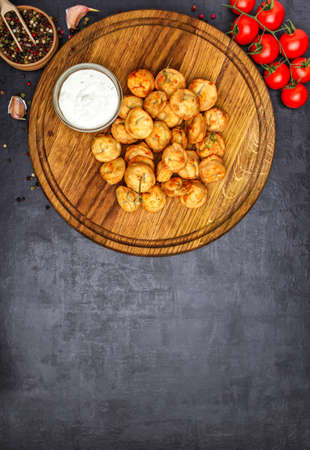 Dumplings stuffed with meat sprinkled with fresh herbs , top view, black backgroundの写真素材