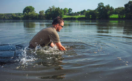 Happy angler with carp fishing trophyの写真素材