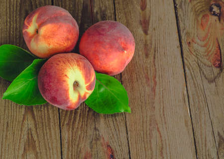 fresh peaches on wooden tableの写真素材