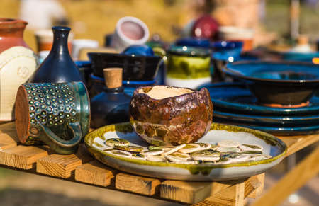Ukrainian pottery. Pottery museum in Ukrainian village Oposhnya, center of Ukrainian pottery production. Different pottery products: bowls, pitchers, plates in museum.の写真素材