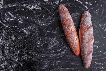 baguette on black background top view copy spaceの写真素材