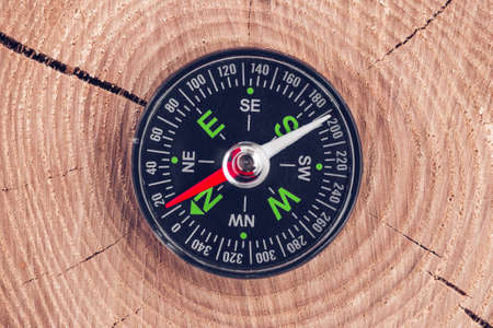 compass on wood background concept for direction, travel, guidance or assistanceの写真素材