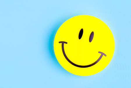 Smiling emoji. Ðn blue backgroundの写真素材
