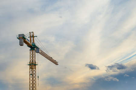 silhouette crane construction site on sunset time background の写真素材