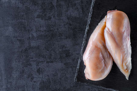 Raw chicken fillet with spices and herbs top viewの写真素材