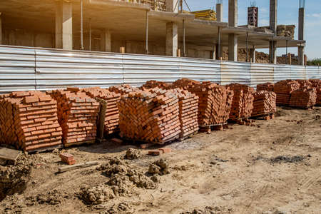 Construction site background. Hoisting cranes and new multi-storey buildings. I.ndustrial background.Building construction site work against blue skyの写真素材