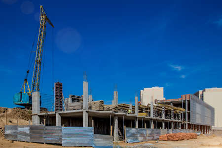 Construction site background. Hoisting cranes and new multi-storey buildings. I.ndustrial...