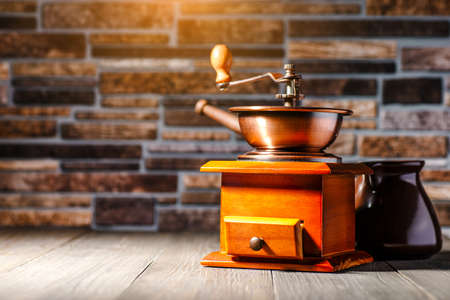 still life with coffee beans and old coffee mill on the wooden background,coffee grinder,coffee...