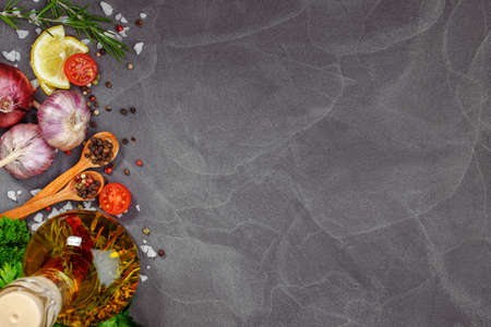 Fresh herbs and spices on black stone table. Cooking concept.Free space for your text. Rustic style. Copy spaceの写真素材