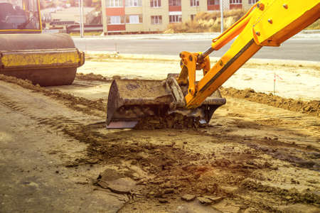 Working Excavator Tractor Digging A Trench At Construction Site.Close-up of a construction site excavatorの写真素材