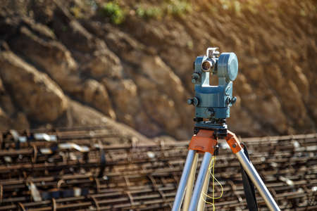 Surveyor equipment GPS system or theodolite outdoors at highway construction site.Measuring instrument close-up. Surveyor engineering with total stationの写真素材
