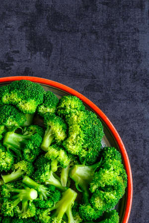 Macro photo green fresh vegetable broccoli. Fresh green broccoli on a black stone table.Broccoli vegetable is full of vitamin.Vegetables for diet and healthy eating.Organic food.の写真素材