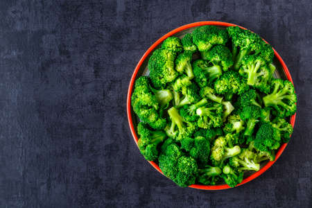 Macro photo green fresh vegetable broccoli. Fresh green broccoli on a black stone table.Broccoli...