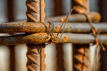 steel rebar for reinforcement concrete at construction site with house under construction background,Industrial background.Rusty rebar for concrete pouring.の写真素材
