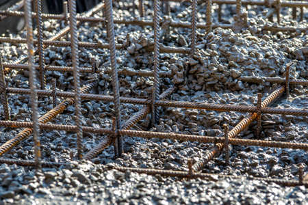 steel rebar for reinforcement concrete at construction site with house under construction background,Industrial background.Rusty rebar for concrete pouring.の写真素材