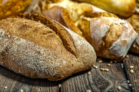 loaf of bread on wooden background, food closeup.Fresh homemade bread.French bread. Bread at...