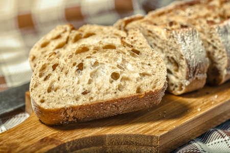 loaf of bread on wooden background, food closeup.Fresh homemade bread.French bread. Bread at leaven.Ciabatta.の写真素材
