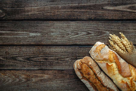 loaf of bread on wooden background, food closeup.Fresh homemade bread.French bread. Bread at leaven.Ciabatta.の写真素材