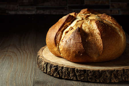 Freshly baked traditional bread on wooden table, with copy space, food closeup. Whole grain rye...