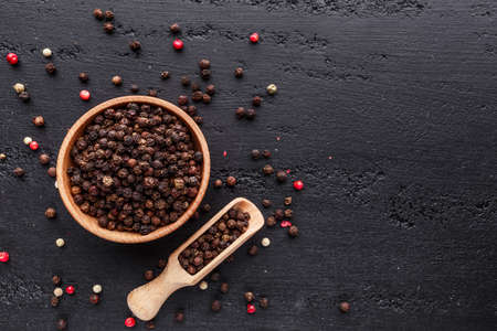 A set of peppers.Collage of different type pepper, Black ,white, pink and allspice peppercornsr, dried chili pepper.Top view. On a black background. free space for your text.の写真素材