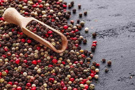 A set of peppers.Collage of different type pepper, Black ,white, pink and allspice peppercornsr, dried chili pepper.Top view. On a black background. free space for your text.の写真素材