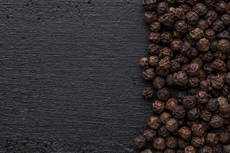 Peppercorn background. Dry black pepper seeds. Top view.On a black background. free space for your text.の写真素材