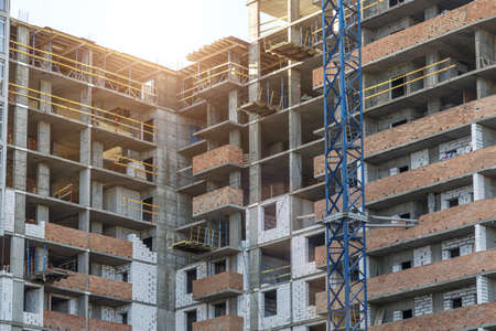 Extensive scaffolding providing platforms for work in progress on a new apartment block,Tall...