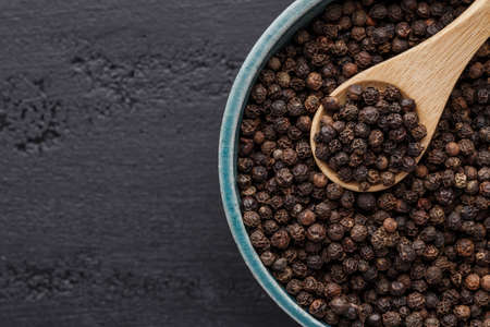 Peppercorn background. Dry black pepper seeds. Top view.On a black background. free space for your text.の写真素材