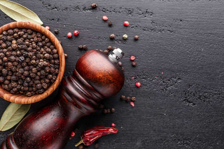 A set of peppers.Collage of different type pepper, Black ,white, pink and allspice peppercornsr, dried chili pepper.Top view. On a black background. free space for your text.の写真素材