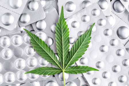 Marijuana leaf and medical pills.Legalizing marijuana for medical purposes.Hemp buds - medical marijuana concept.COVID 19 Coronavirus,の写真素材